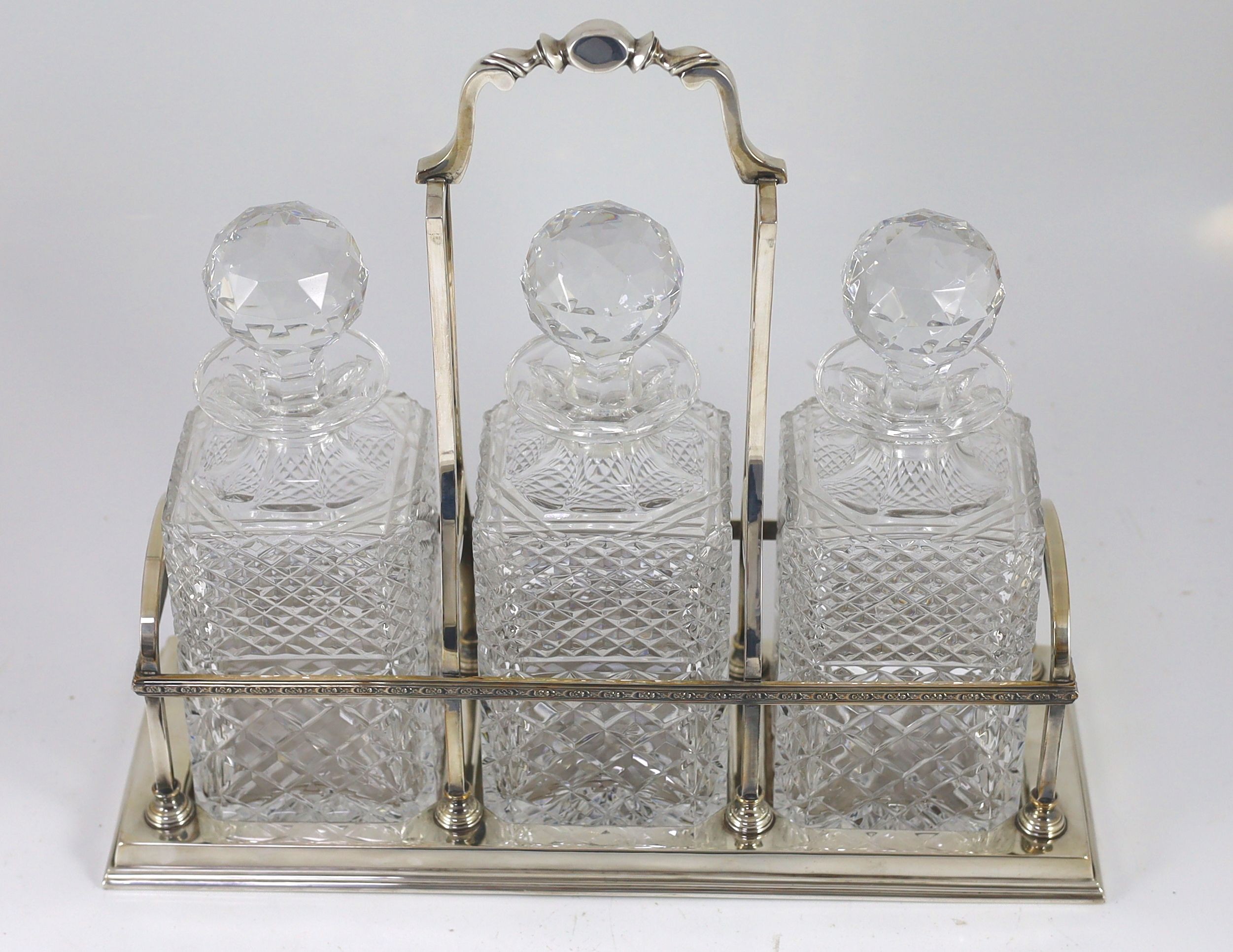 A modern silver three bottle rectangular decanter stand, by C.J. Vander Ltd